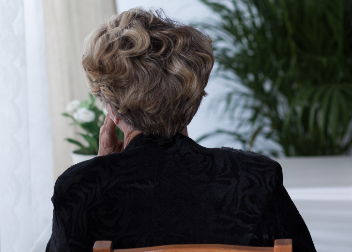 Older woman overwhelmed with loss of spouse